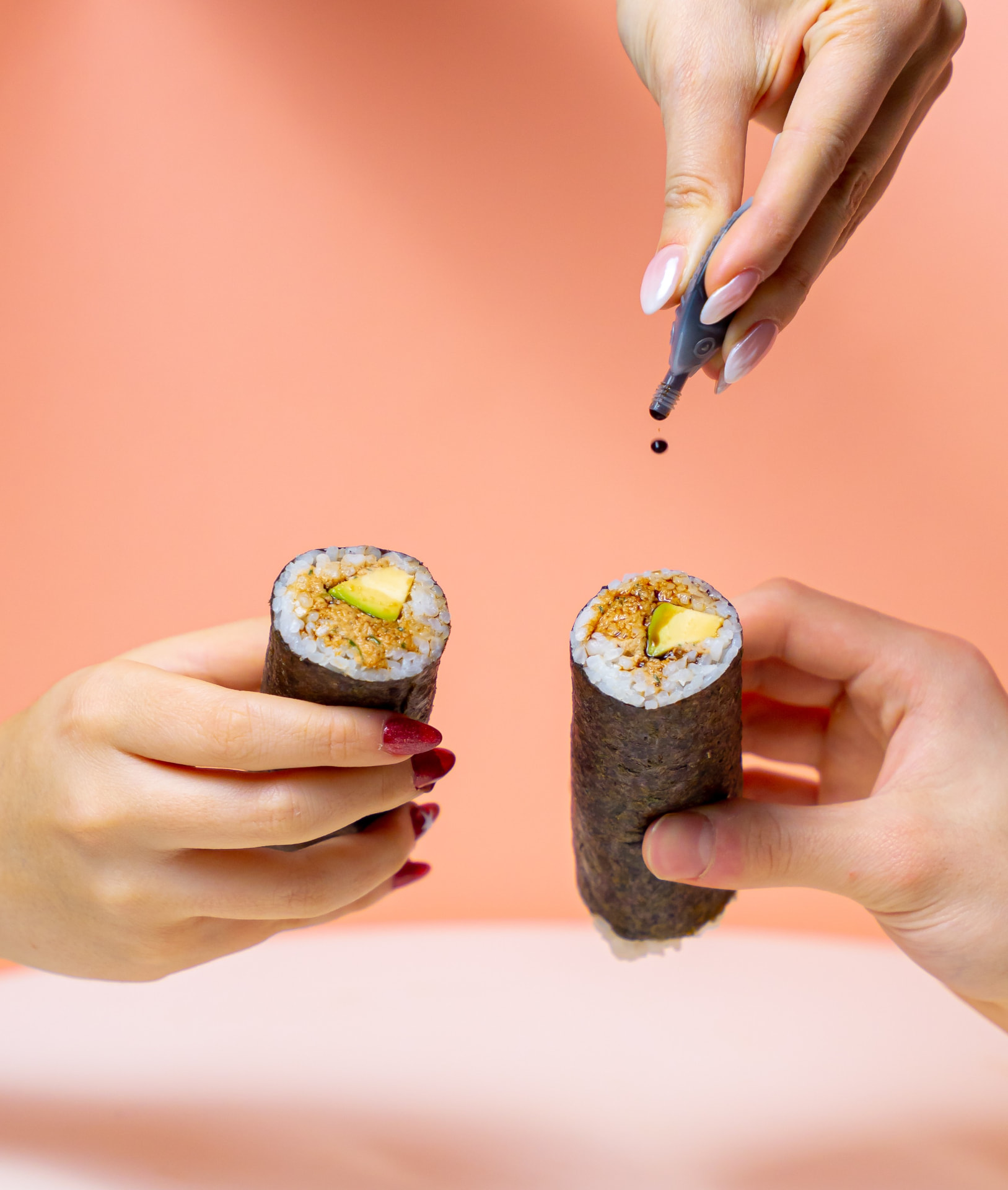 Soy sauce being poured over a MAKU roll